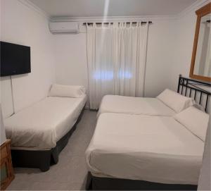 Postel nebo postele na pokoji v ubytování Hostal Playa Hidalgo