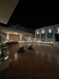 a large empty room with lights in a building at night at شاليه فرحتي in Al Madinah