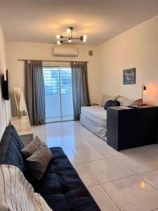 a living room with two beds and a couch at Luminoso departamento con cochera in San Juan