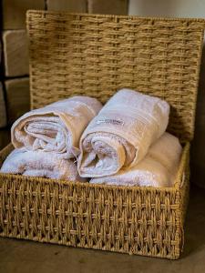 a basket full of wrapped towels sitting on the floor at Bangalô de Pedras in São Thomé das Letras
