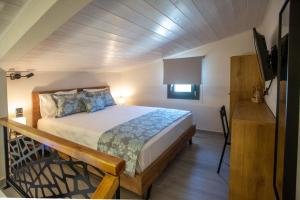 a bedroom with a large bed in a room at ONAR PALACE in Nea Peramos