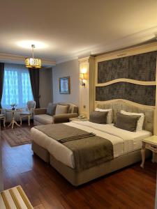 a bedroom with a large bed and a living room at Muyan Suites in Istanbul