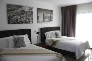 Postel nebo postele na pokoji v ubytování HOTEL MINA REAL