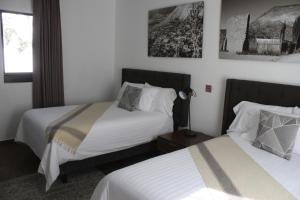Postel nebo postele na pokoji v ubytování HOTEL MINA REAL