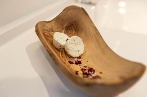 a wooden spoon with three pieces of food in it at Mini Chalet Assinie Spa Privé, Nature & Golf in Brownsburg +24 photos