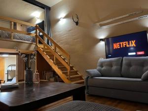 a living room with a netflix sign on the wall at LF LEVEL Sierra Nevada Duplex in Sierra Nevada