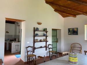 a living room with a table and chairs and a room with a table at Casa Tamurrà in Galati Mamertino