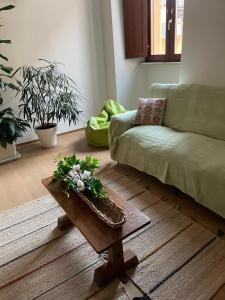 a living room with a couch and a coffee table at La Pulchella in LʼAquila