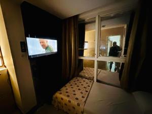 a bedroom with a tv and a bed in a room at Panoramic Partation with Amazing View close to Mall Of Emirates in Dubai