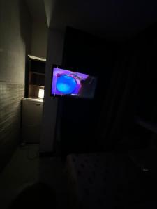a television in a dark room with a blue screen at Panoramic Partation with Amazing View close to Mall Of Emirates in Dubai