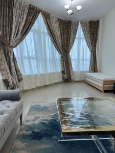 een woonkamer met een bank en een tafel bij F22,R2 Sea&city view room in three bedroom apartment, separate bath outside in Ajman 