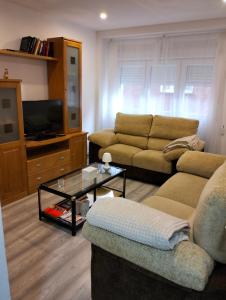 a living room with a couch and a coffee table at Casa Raquelina in Gijón