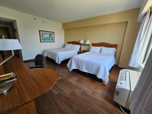 a hotel room with two beds and a table at Fiesta Inn Tampico in Tampico +41 photos