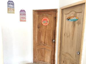 a wooden door with stickers on it in a room at Estela, habitación privada de Flor de Lis Beach House in Playas