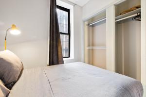a bedroom with a bed and a window at Step inside Central Living in Times Square in New York