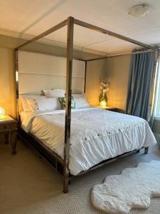 a bedroom with a large bed with a canopy at Royal highland livingroom bedroom suite in Calgary