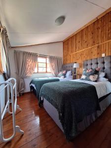 a bedroom with two beds and a window at Nyala Bush Cabin in Polokwane