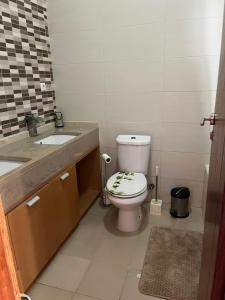 a bathroom with a toilet and a sink at Nerys House in São Filipe