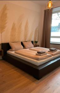 a large bed in a room with a window at Augusta in Koblenz