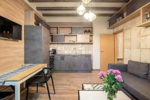 a kitchen and a living room with a couch and a table at 1bdr Trendy Interior Vitoshka Area Ac in Sofia