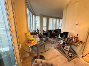 a living room with a table and a couch at Penthouses of Beach Ave in Vancouver