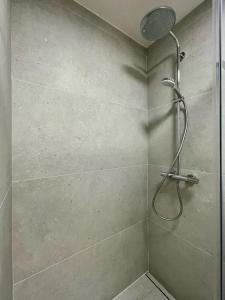 a shower with a shower head in a bathroom at Apartment Jasná Lúčky Demänovská Dolina DD97 in Belá