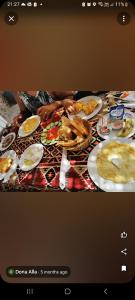 a picture of a table with plates of food at Villa golden life apartments, new property with pool access in Luxor
