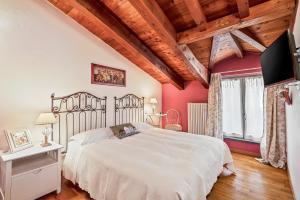 - une chambre avec un grand lit blanc et des murs rouges dans l'établissement Affittacamere La Collina Degli Ulivi, à La Spezia