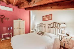 a bedroom with a white bed and a table at Affittacamere La Collina Degli Ulivi in La Spezia