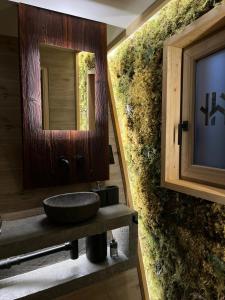 a bathroom with a sink and a mirror at Treedom in Prievidza