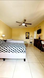 1 dormitorio con 1 cama y ventilador de techo en Alojamiento River Merendón en San Pedro Sula
