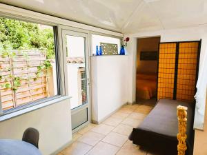 a room with a window and a table and a bed at Antibes Port de Salis Appart 3p in Antibes