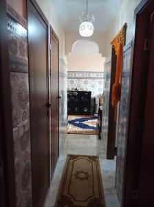 a hallway with a door and a room with a bed at Al fajar2 in Alimadene
