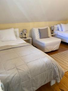 a bedroom with two beds and a couch at Apartment Dea in Kolašin