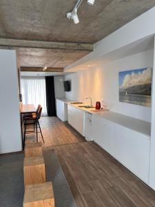 a kitchen with white cabinets and a table and a dining room at Departamentos en Gral Paz a pasos de clínicas in Cordoba