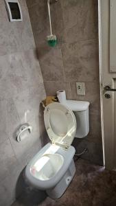 a bathroom with a white toilet in a room at Roki in Villa Gesell