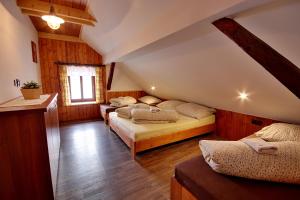 a bedroom with four beds in a attic at Chalupa Chlum Míša in Volary