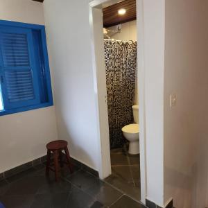 a bathroom with a toilet and a stool at Casas MDP ilhabela/2 in Ilhabela