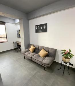 a living room with a couch and a table at Apartamento Loft Bogotá in Bogotá