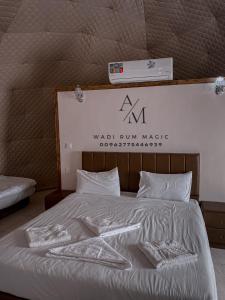 a bed with a wal firm maker sign above it at WADi RUM MAGIC CAMP in Wadi Rum