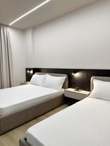 een slaapkamer met 2 bedden en een bank bij N7 apartment in Durrës