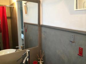 a bathroom with a mirror and a sink and a tub at La Petite Maison sur l'Ile de Ré in La Flotte