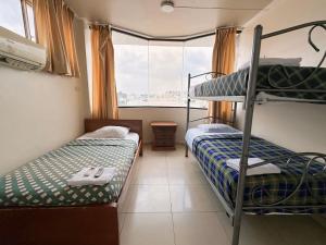 Voodi või voodid majutusasutuse Hostal Posada Del Sol toas
