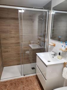 a bathroom with a shower and a sink at Diamante de la Bahia in Caleta De Fuste