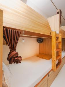 a bunk bed in a small room with a ladder at Sahara Dormitory in Mumbai
