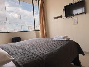 Voodi või voodid majutusasutuse Hostal Posada Del Sol toas