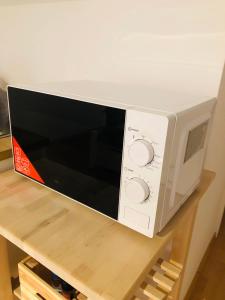a microwave oven sitting on top of a shelf at Modernes Apartment in Waldstetten in Waldstetten
