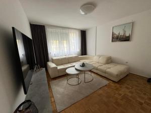 a living room with a couch and a table at Estrada Apartment in Sarajevo