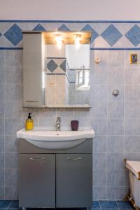 a bathroom with a sink and a mirror at Panos house in Hanioti