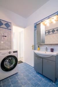 a bathroom with a washing machine and a sink at Panos house in Hanioti